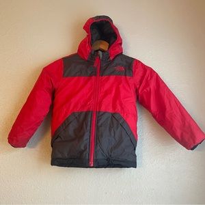 The North face kids reversible jacket. Raincoat on one side and soft on other